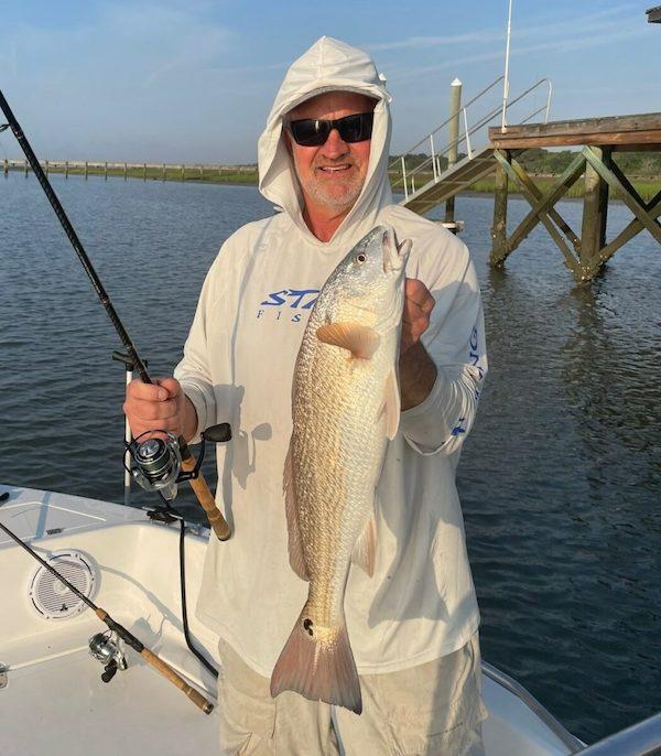 Gary Borland, SAFMC council member, holding a red fish.