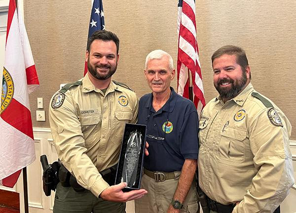 L-R Officer Chris Demeter, Council Chair Mel Bell, and Master Officer Clay McDonough pose for the Lw Enforcement Officer of the Year Award.