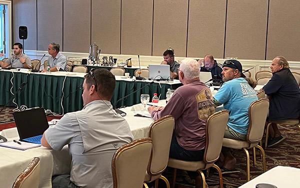 Snapper Grouper Advisory Panel members discuss fishery issues around a table.